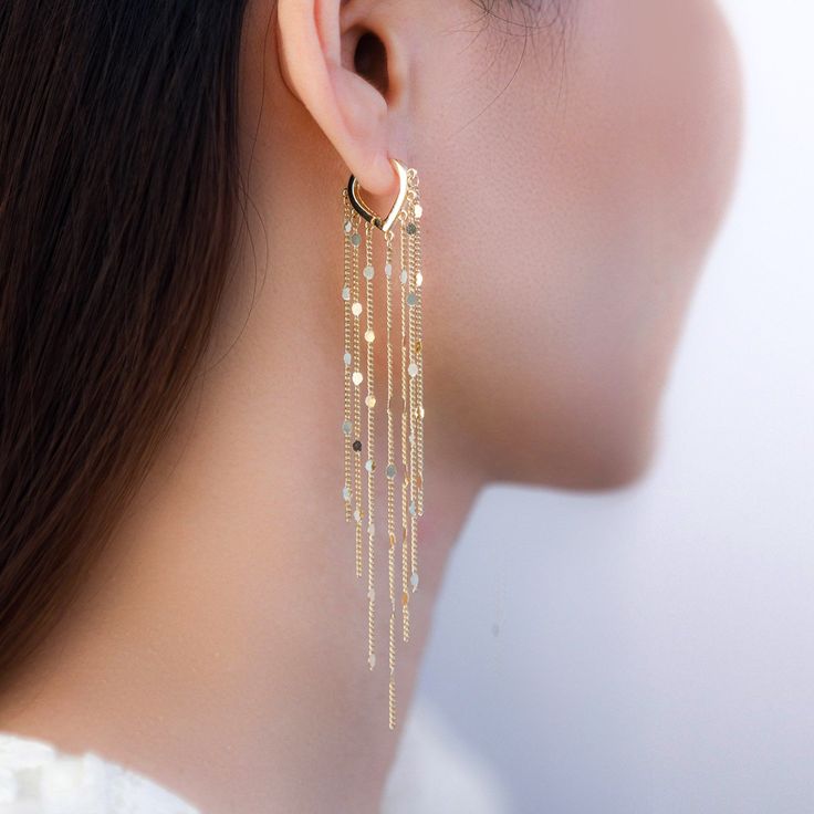 The metal chain tassel hoop earrings feature long tassel chains with sparkling texture to capture light refection and make you shine. These metal tassel chains hoop earrings are perfect for party outfit and everyday wear. Trendy Fringe Metal Jewelry, Dangle Threader Earrings With Adjustable Chain For Party, Elegant Tassel Hoop Earrings, Party Tassel Dangle Earrings With Dangling Charms, Metal Tassel Dangle Earrings With Fringe, Trendy Dangle Chain Hoop Earrings, Trendy Metal Dangle Threader Earrings, Long Drop Metal Tassel Earrings, Metal Long Drop Tassel Earrings