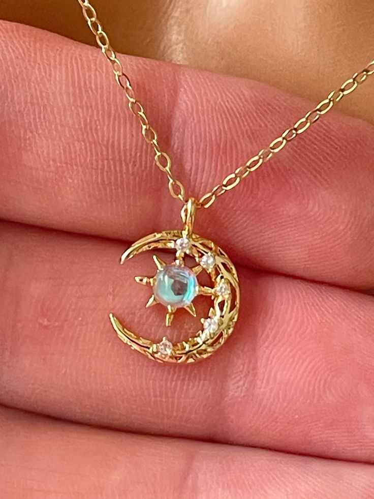 This is a darling 14 karat gold filled moon and star charm necklace. This lovely charm features a lab created opal along with pave crystals set in 14 K gold-filled.  Such a beautiful dainty charm that measures 15x11mm and comes on a shiny cable chain with spring clasp and back.  Model is wearing a 16 inch length. Entire necklace is 14K gold filled.Please choose your desired length and the drop-down list. Comes in a gift box ready to present. Necklaces Opal, Dainty Moon Necklace, Moon Necklaces, Star Charm Necklace, Magical Jewelry, Dress Indian, Pretty Jewelry, Moon And Stars, Necklace Dainty