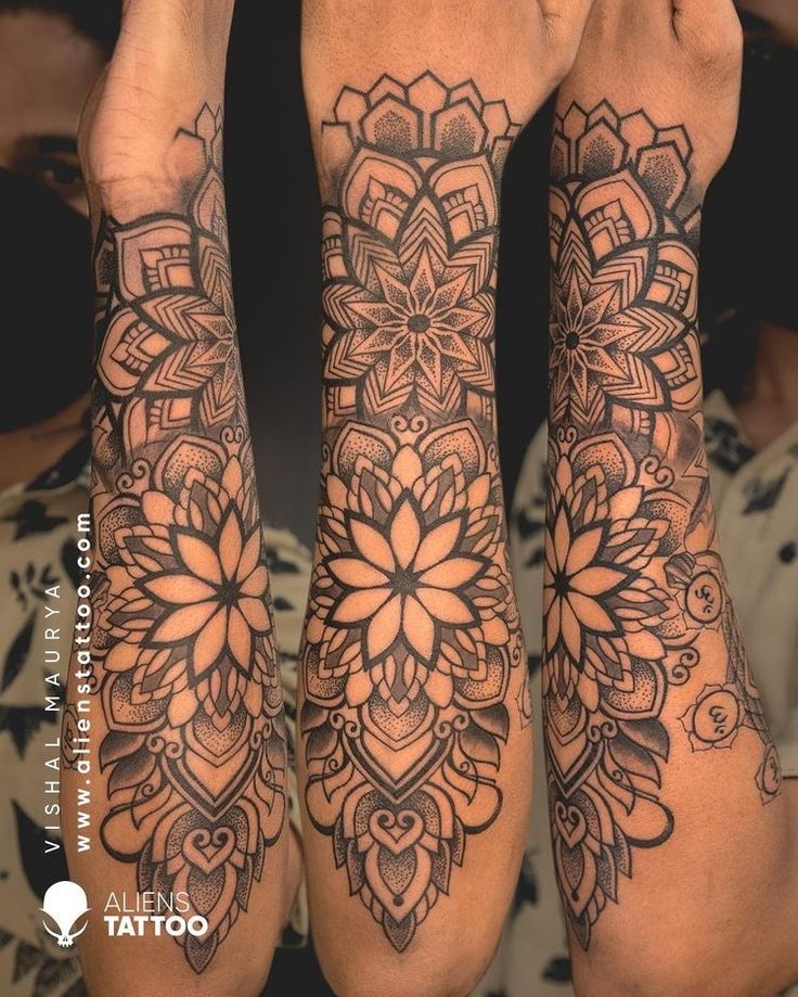 two people with tattoos on their arms and legs, both holding hands up to their faces