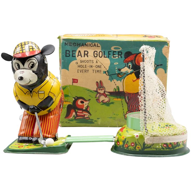 a figurine of a bear golf player next to an old fashioned tin box