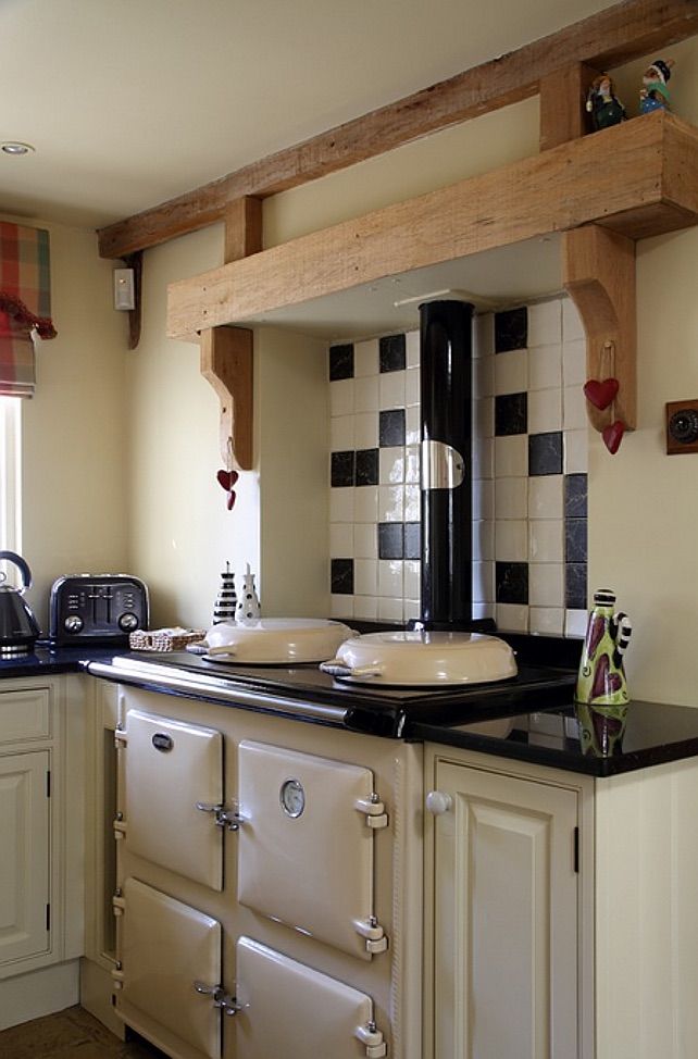 a stove top oven sitting inside of a kitchen next to a sink and countertop