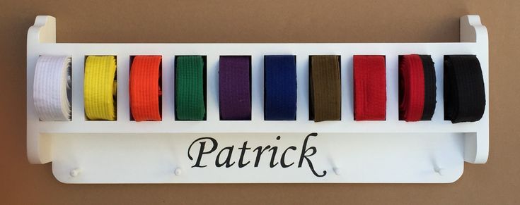 there is a rack that has different colored ribbons on it and the word patrick written in black