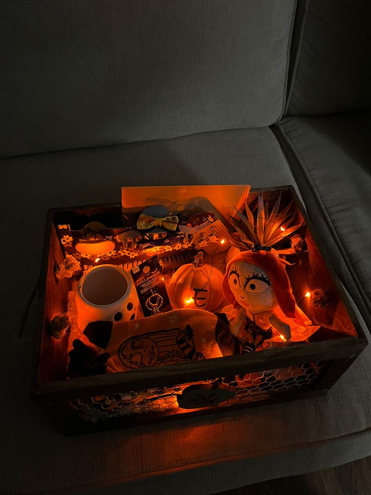 a box filled with candles sitting on top of a couch