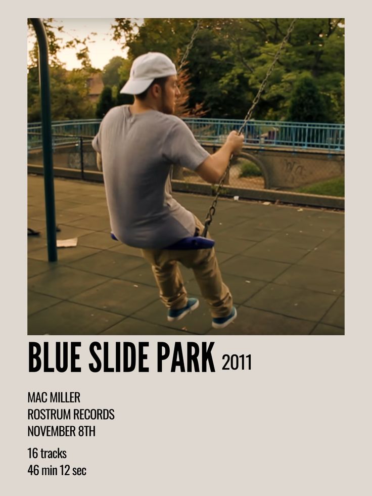 a man on a swing in the middle of a park with blue slide park 2011