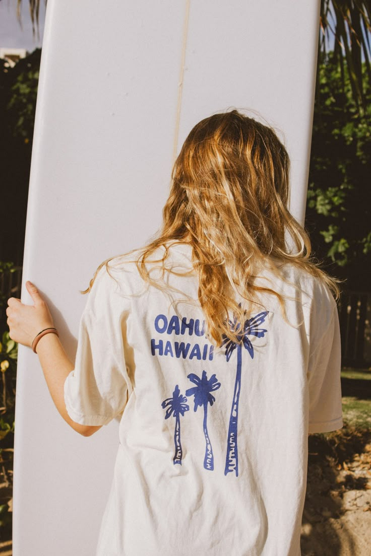 Best Selling 'Palm Tree Paradise' Tee is hand lettered and screen printed in blue inkIvory Comfort Colors Tee is 100 % Ring Spun US CottonComes in sizes S-XL (Models are wearing a size Large in pictures!)Hang to dry for the longest lasting life of tee! We would love to see you with your new tee! Please tag us @thesaltyblonde.co on Instagram! No refunds or exchanges at this time. If you have any issues with your order please reach out to our email at thesaltyblondeshop1@gmail.com Vintage Surf Graphic Tee, Beach Merch Photoshoot, Screen Printing Shirts, Cute Graphic Tees, Blue Tee, Yoga Shirts, Comfort Colors Tee, Surfer Girl, Branded Shirts