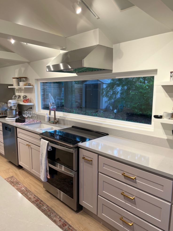 a kitchen with stainless steel appliances and white counter tops