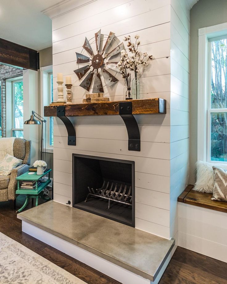 a living room with a fire place next to a window and a tv on the wall