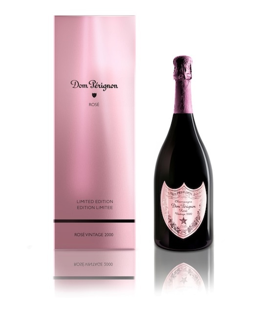 a bottle of champagne next to a pink box