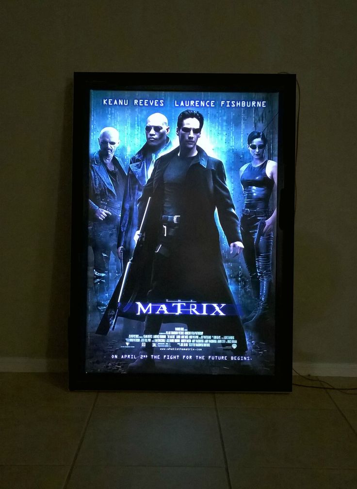 a movie poster on the wall in a room with tile flooring and white walls