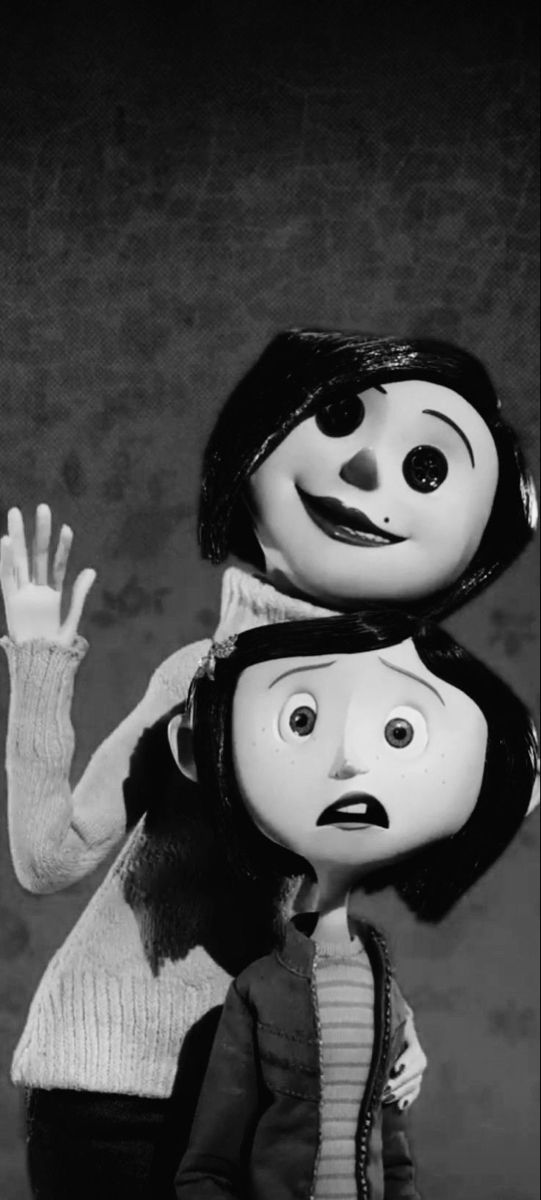 an image of two dolls that look like they are being held up by someone's hand