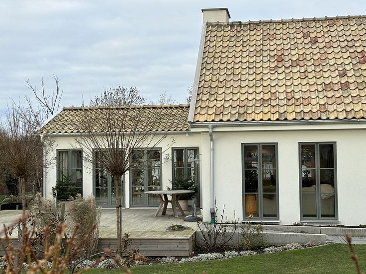 a small white house with a tiled roof