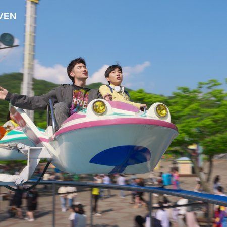 two people riding on a ride at an amusement park