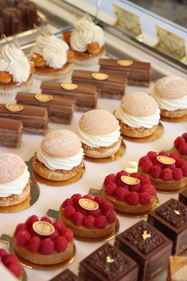 desserts and pastries on display in a bakery