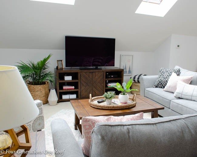 a living room filled with furniture and a flat screen tv on top of a wooden table