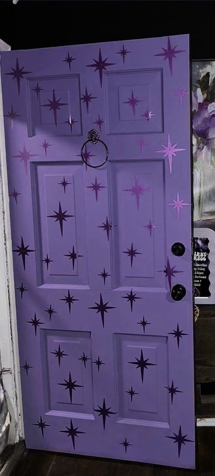 a purple door with stars painted on it