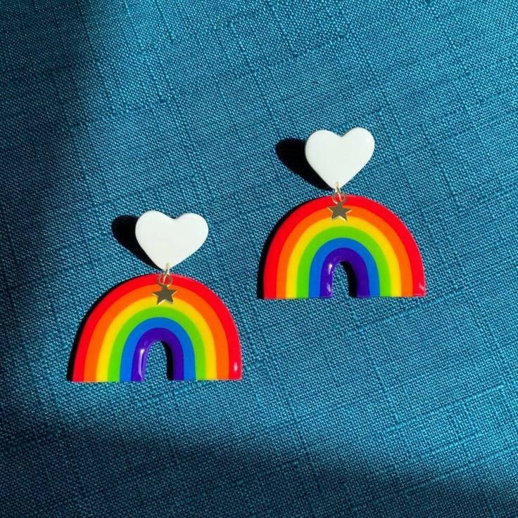 two heart shaped earrings with a rainbow design on the front and back of each ear