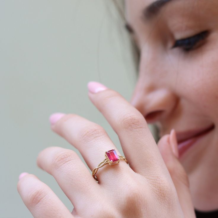 "This vintage inspired ring is set with a beautiful pink Ruby to make you feel like a princess A dainty and unique Celtic pattern to encircle your finger. Handmade by an inspired jewelry artist team with decades of experience in the craft of jewelry making. Each gemstone, each diamond is carefully picked. Using only the finest raw materials and the highest industry standard in manufacturing, design and finish. Set with a 7x5 Octagon cut Pink Ruby 1.06 ct All ring sizes available, if you cannot f Elegant Pink Gold Birthstone Promise Ring, Pink Gemstone Stackable Promise Rings, Elegant Pink Ruby Promise Ring, Elegant Pink Stackable Rings, Elegant Pink Emerald Cut Ring, Pink Solitaire Dainty Jewelry, Delicate Emerald Cut Promise Ring, Dainty Pink Stackable Rings For Wedding, Dainty Pink Solitaire Ring