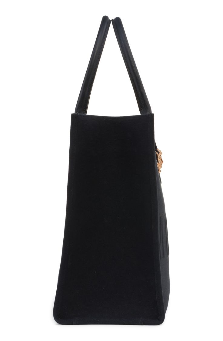 A signature Medusa head beautifully highlights this softly structured canvas tote subtly embossed with a typeface logo. Large enough to carry your laptop and all your other essentials, this streamlined style is sure to be a favorite season after season. Bridge snap-tab closure Top carry handles Interior zip pocket Textile Made in Italy Designer Handbags Black Canvas Shoulder Bag With Gold-tone Hardware, Black Canvas Bags With Gold-tone Hardware, Elegant Canvas Shoulder Bag With Branded Hardware, Elegant Canvas Business Bags, Elegant Business Canvas Bag, Elegant Business Canvas Bags, Elegant Canvas Shoulder Bag For Business, Typeface Logo, Versace Gold