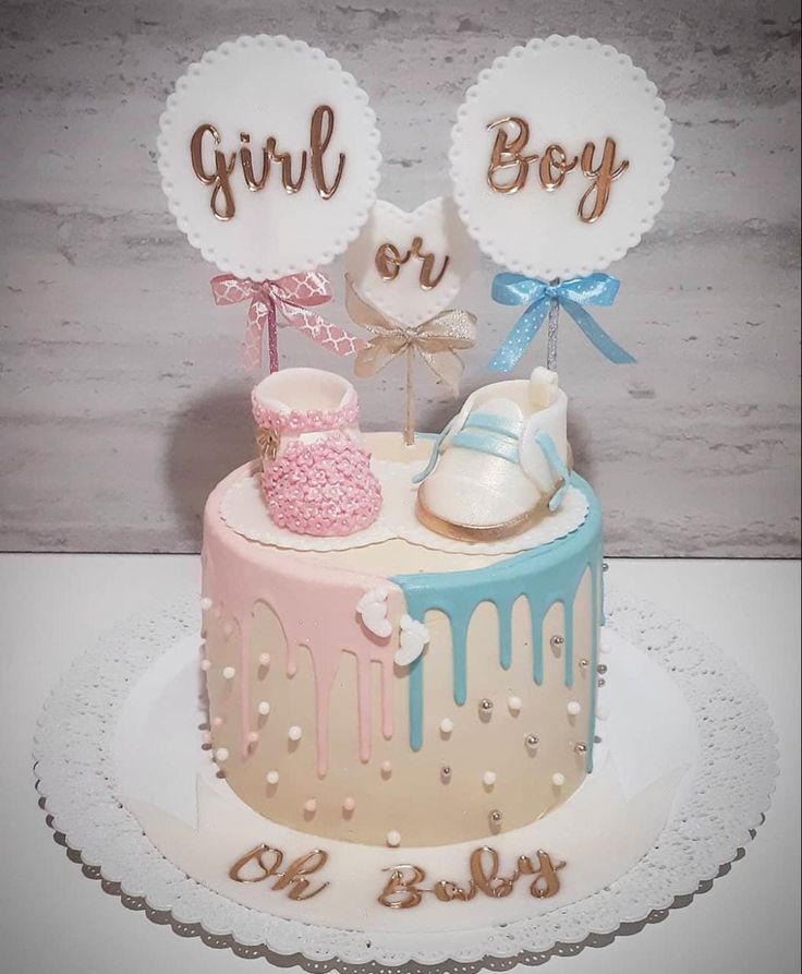 a baby shower cake with its name on the top and it's booties