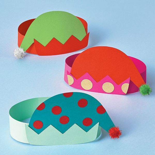 three paper hats with pom poms on them