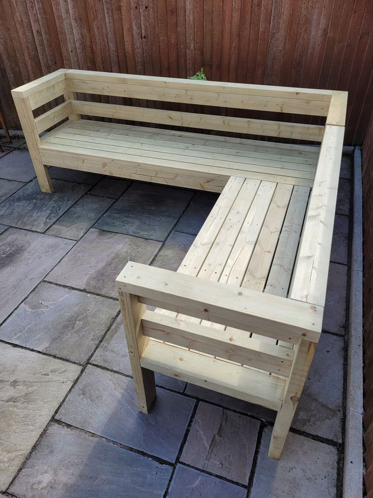 a wooden bench sitting on top of a stone patio