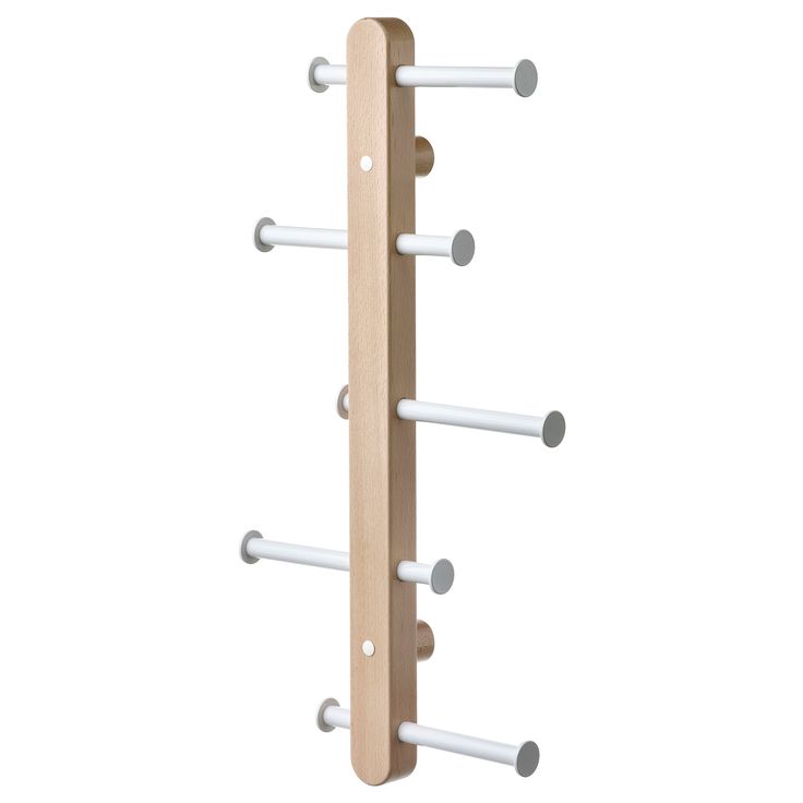 a wooden coat rack with four white rods and two grey knobs on each end