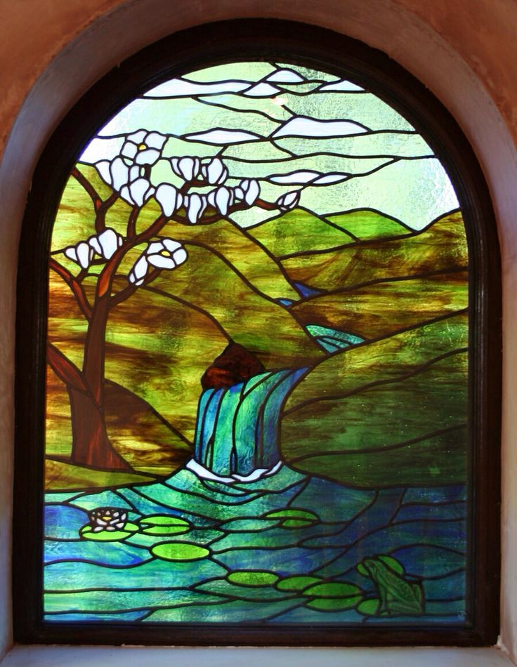 a stained glass window with a waterfall in it