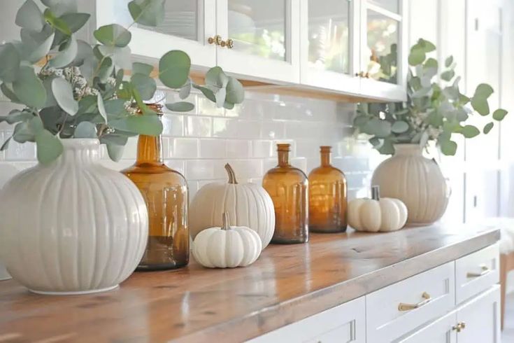 some white pumpkins are sitting on a counter