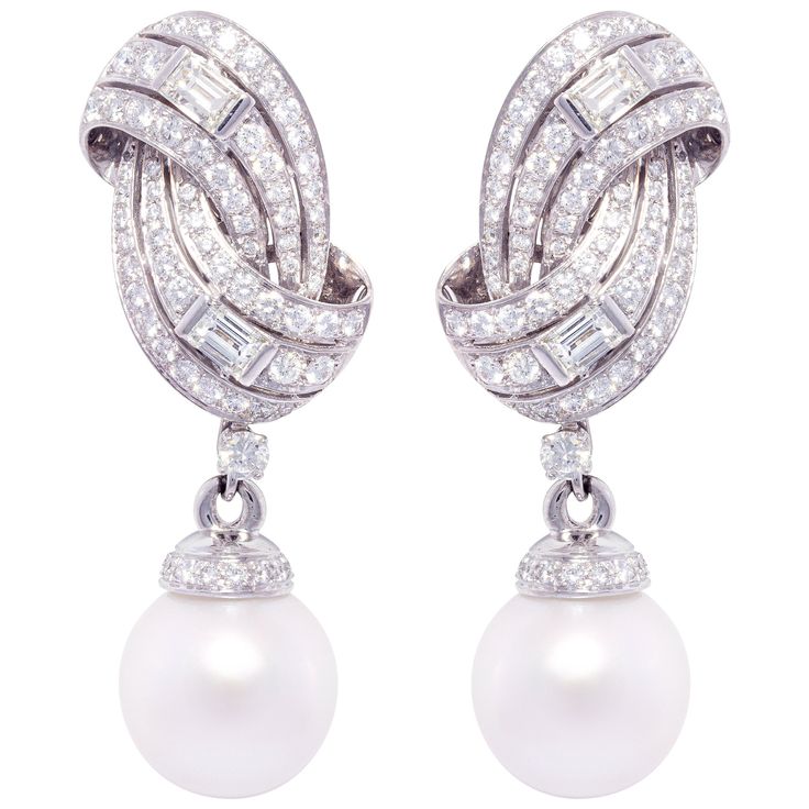 The South Sea pearl and diamond earrings feature a swirl design on the ear with 4.86 carats of round diamonds accented with 4 large custom-cut baguette diamonds weighing 1.24 carats. The tops suspend 2 very fine detachable South Sea pearls of 16mm diameter. All of our pearls are untreated: their natural color and high luster have not been enhanced in any way. All of our diamonds are of top quality (F/G-VVS, color, clarity, and cut). The earrings are one-of-a-kind. They were handmade in Italy in White Diamond Pearl, Baguette Diamond Earrings, Gold Bangles For Women, Pearl Jewels, Pearl And Diamond Earrings, Luxury Earrings, Baguette Diamonds, Diana Spencer, Sea Pearl