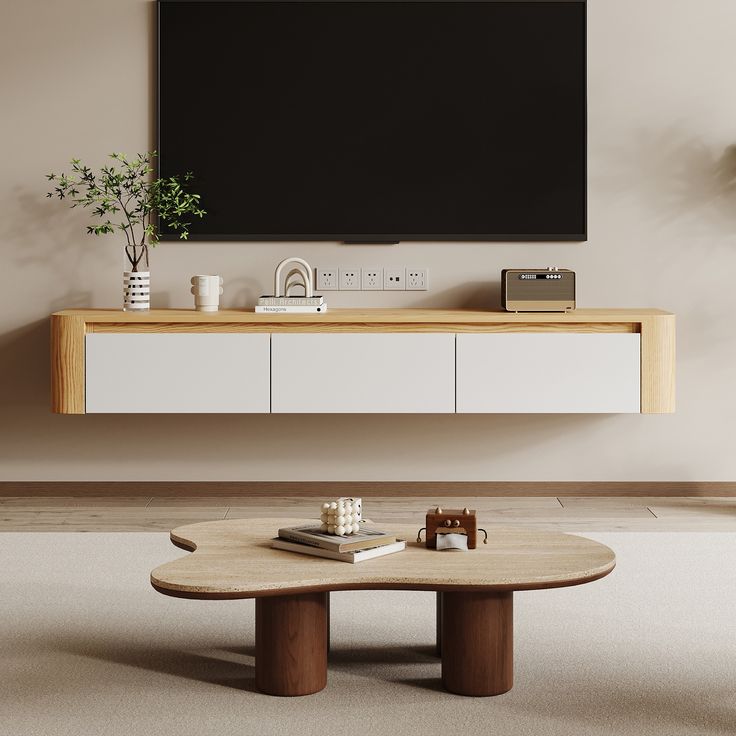 a living room with a large flat screen tv on the wall and coffee table in front of it