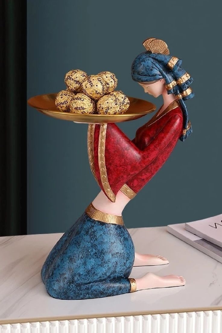 a figurine is holding a tray with cookies on it