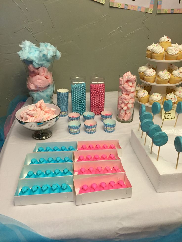 a table topped with cupcakes and candy bars