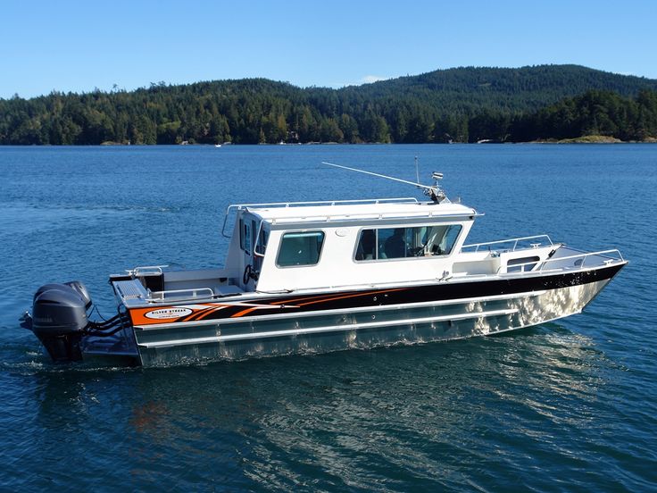 a small boat is out on the water with trees in the backgrouds