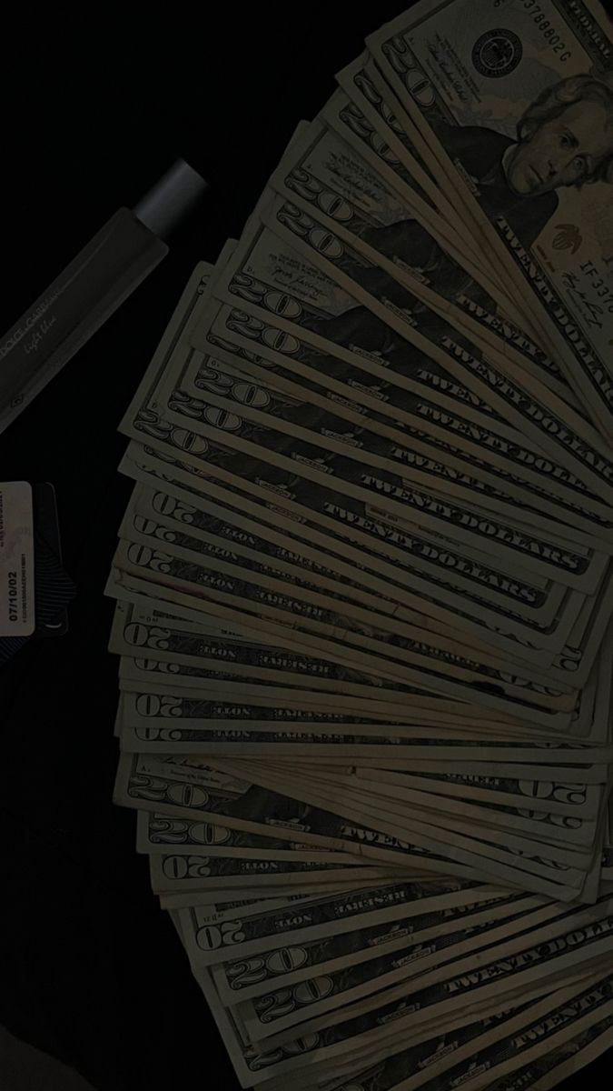 a pile of money sitting on top of a table