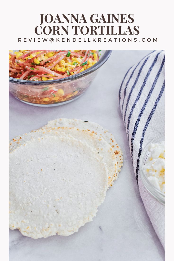 tortillas with corn on the side and a bowl of salsa in the background