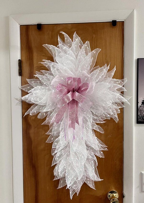 a door with a pink and white bow on it