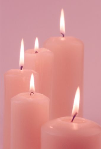 five pink candles with one lit in the middle