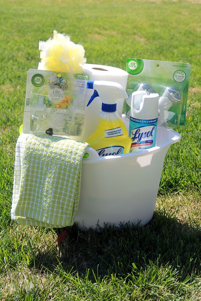 a tub filled with cleaning products on top of a lush green field