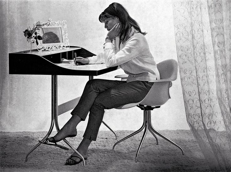 a woman sitting at a table with a chess board