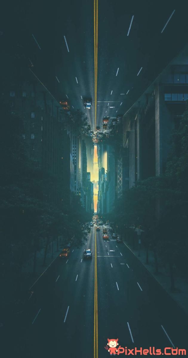 an empty city street at night with cars driving down the road and tall buildings in the background