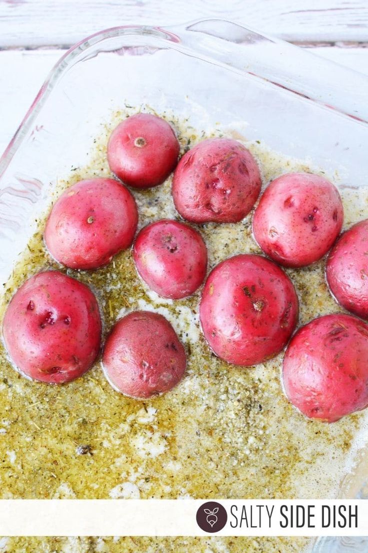 some red potatoes are in a glass dish