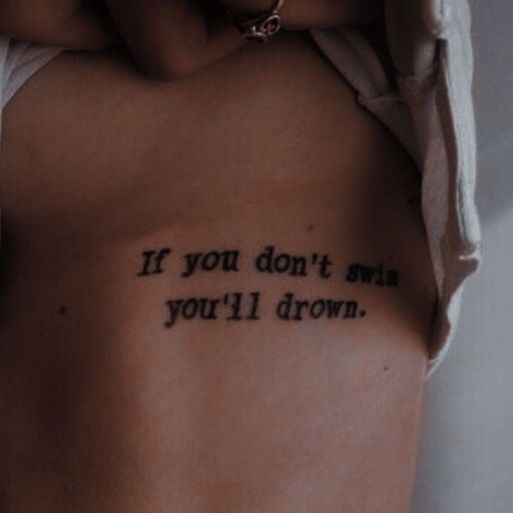 a woman with a tattoo saying if you don't own, you'll drown