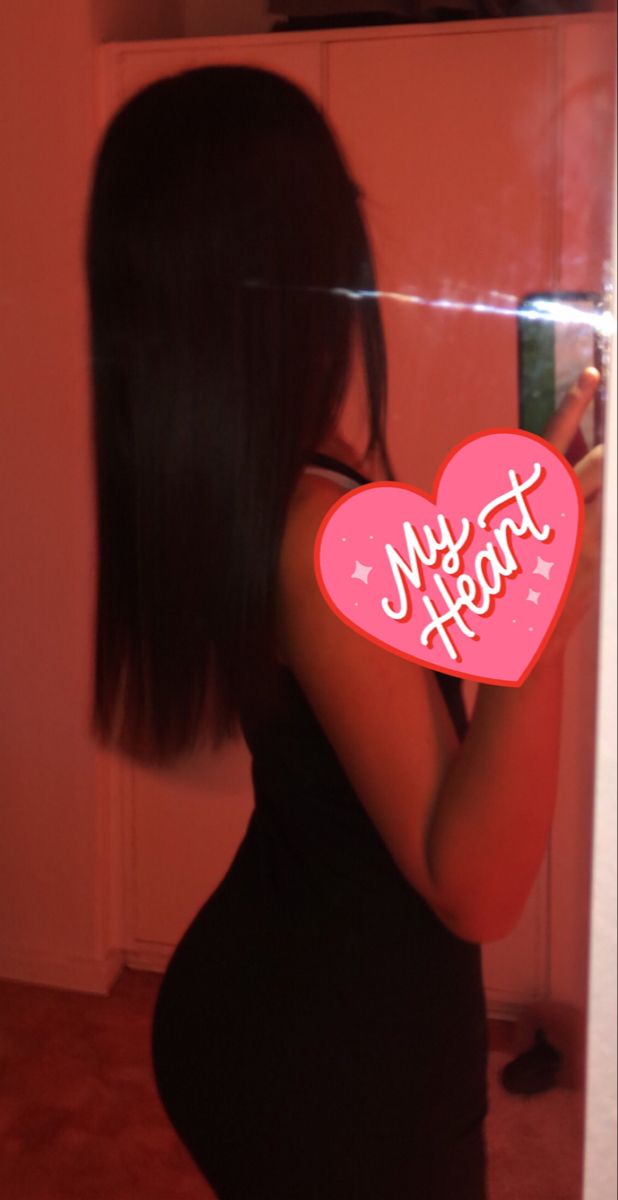 a woman taking a selfie in front of a mirror with the words my heart on it