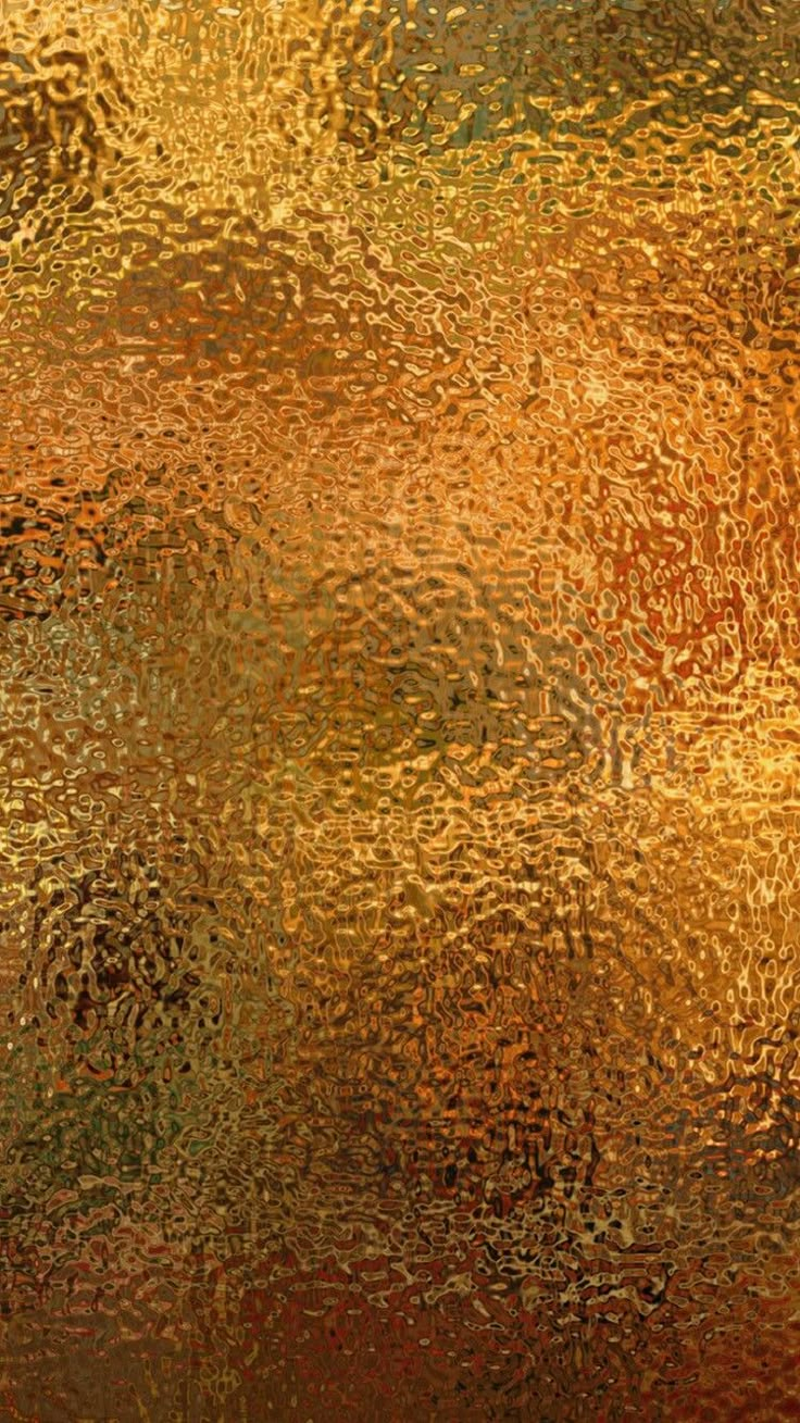 an abstract background with gold and red colors on the glass window sill, as seen from above