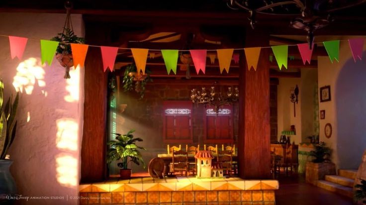 there are many flags hanging from the ceiling in this living room with potted plants