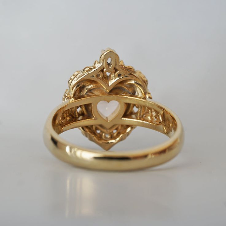 a gold ring with a heart on it