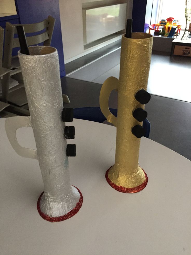 two vases sitting on top of a white table