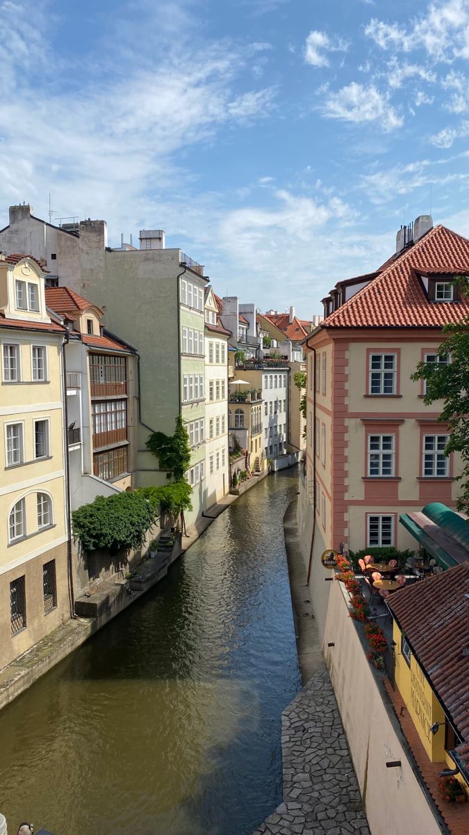 a river running through a city next to tall buildings