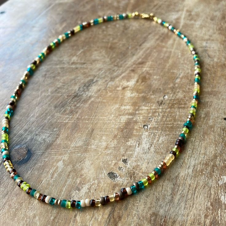 a beaded necklace on a wooden table