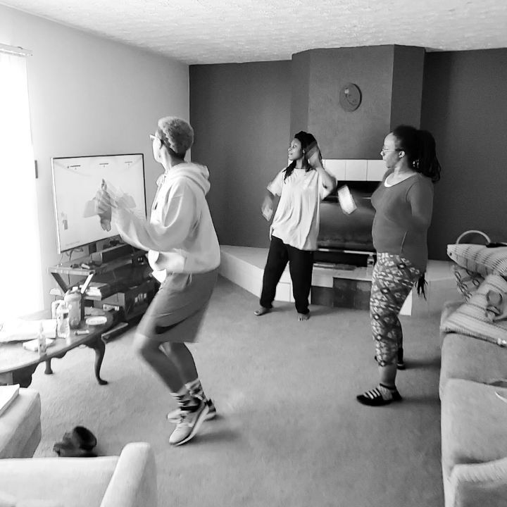 three people in a living room playing video games